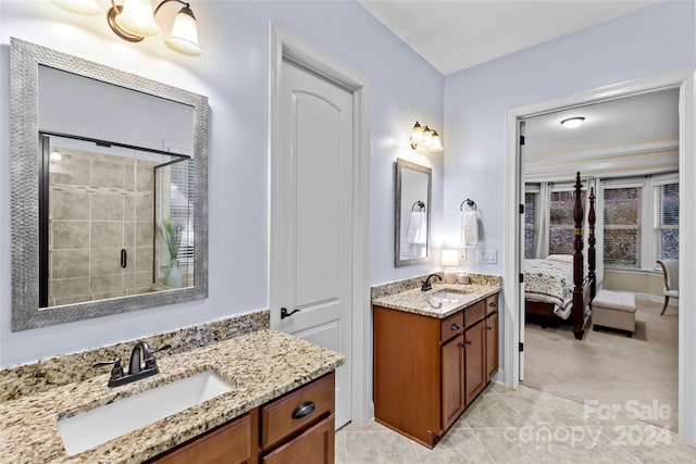 bathroom featuring vanity and an enclosed shower