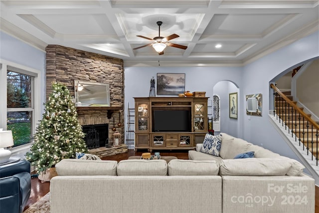 living room with beam ceiling, ceiling fan, coffered ceiling, hardwood / wood-style floors, and a fireplace