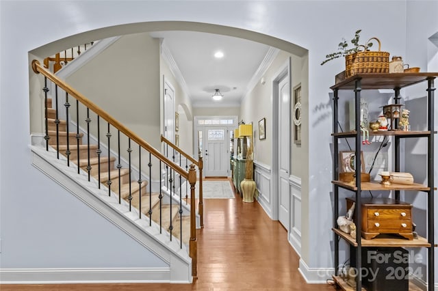 foyer with ornamental molding and hardwood / wood-style flooring