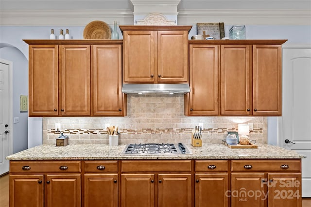 kitchen with tasteful backsplash, crown molding, and stainless steel gas stovetop