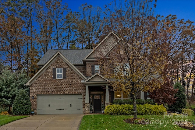 view of front of property featuring a garage and a front yard