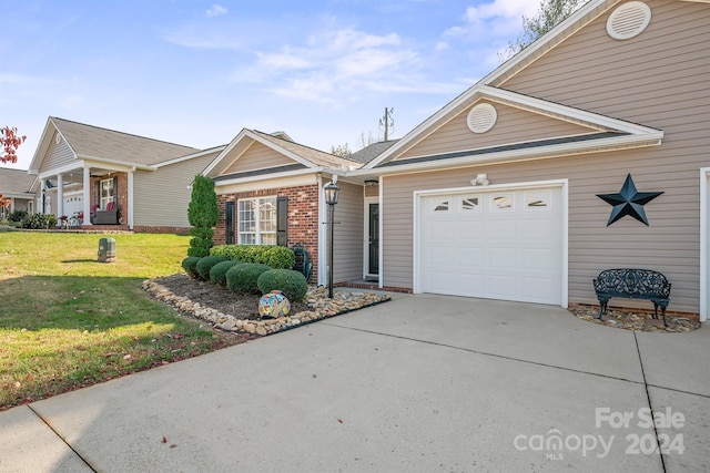 view of front of property with a garage and a front yard