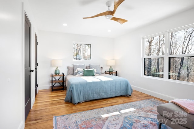 bedroom featuring light wood-type flooring and ceiling fan