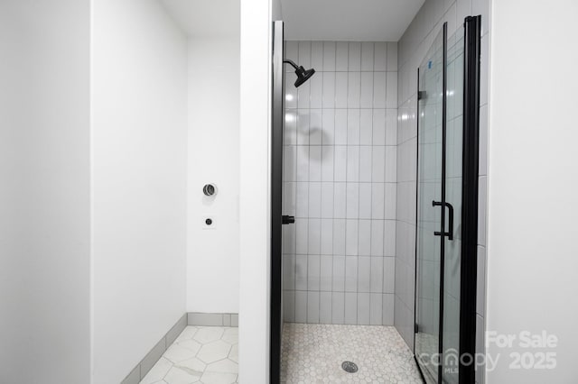 bathroom featuring tile patterned flooring and an enclosed shower