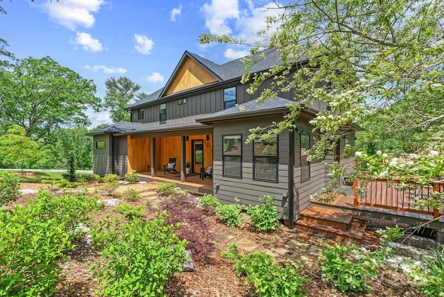 107 Beautyberry Dr, Asheville, NC 28801 - back of property featuring a deck, board and batten siding, a shingled roof, and covered porch