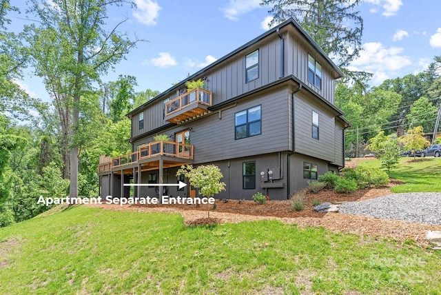 107 Beautyberry Dr, Asheville, NC 28801 - back of property with a balcony, a lawn, and board and batten siding