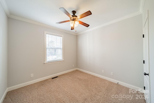 carpeted empty room with ceiling fan and crown molding