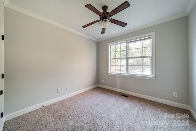 unfurnished room featuring ceiling fan, carpet floors, and crown molding