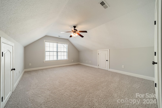 bonus room with carpet, ceiling fan, lofted ceiling, and a textured ceiling