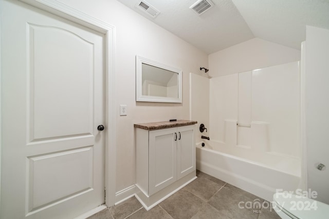 bathroom with tile patterned floors, toilet, shower / tub combination, and vaulted ceiling