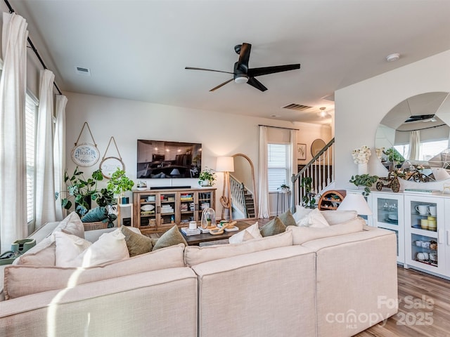 living room with ceiling fan, a healthy amount of sunlight, and wood-type flooring