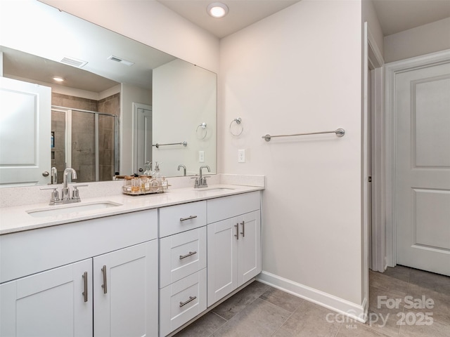 bathroom with vanity, tile patterned floors, and a shower with door