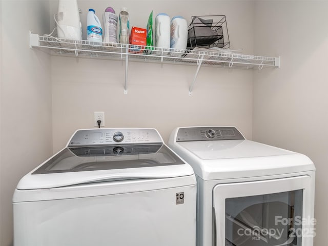 clothes washing area featuring washing machine and clothes dryer