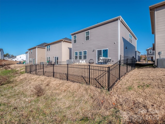 rear view of house featuring central AC unit