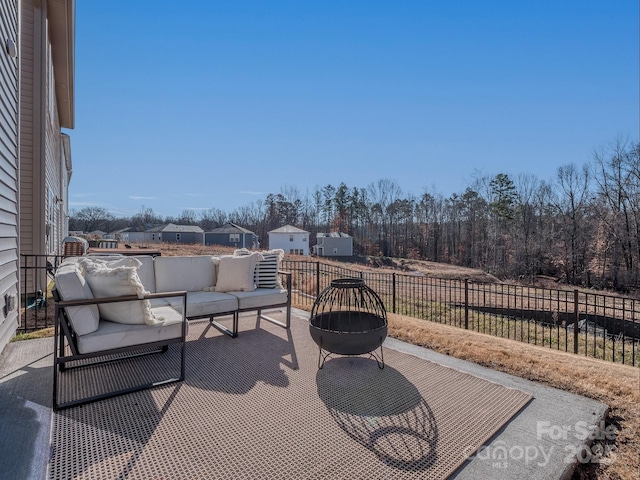 view of patio featuring an outdoor living space with a fire pit