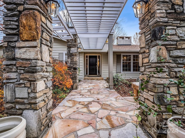 entrance to property featuring a pergola