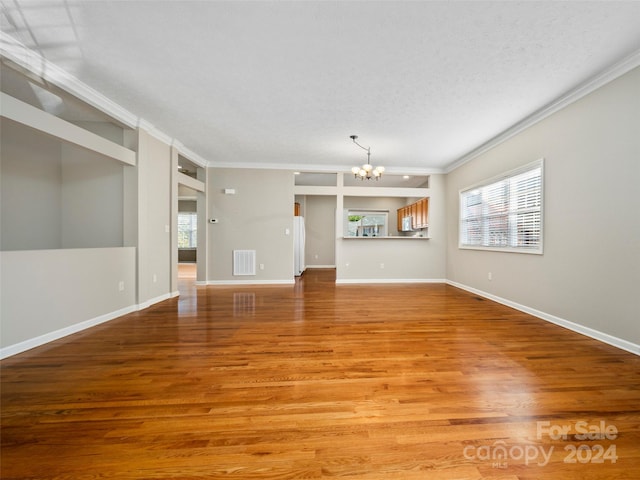 unfurnished living room featuring crown molding and light wood-type flooring