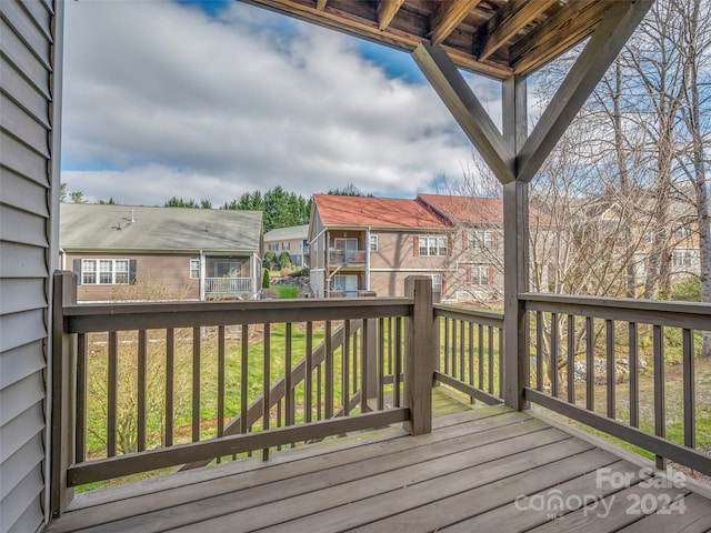 wooden deck featuring a lawn