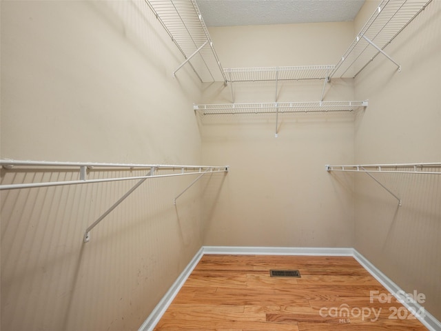 spacious closet featuring hardwood / wood-style floors