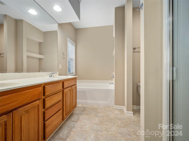 bathroom with vanity, toilet, and a bath