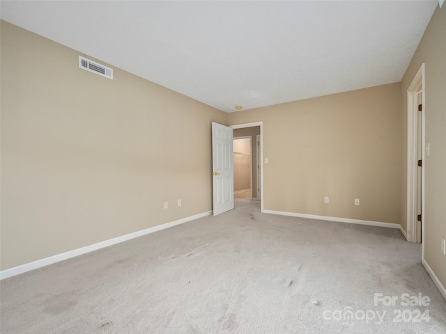 unfurnished bedroom with light colored carpet