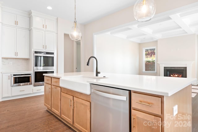 kitchen with sink, stainless steel appliances, an island with sink, light hardwood / wood-style floors, and white cabinets