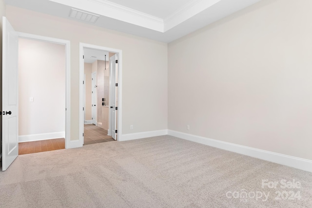 carpeted spare room with crown molding