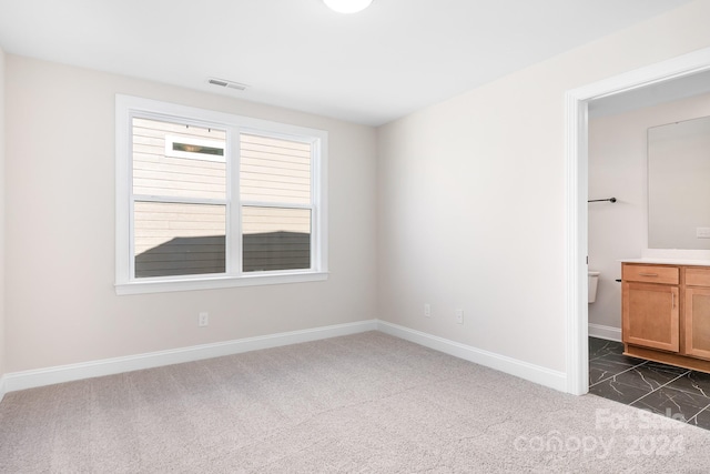 unfurnished bedroom with dark carpet