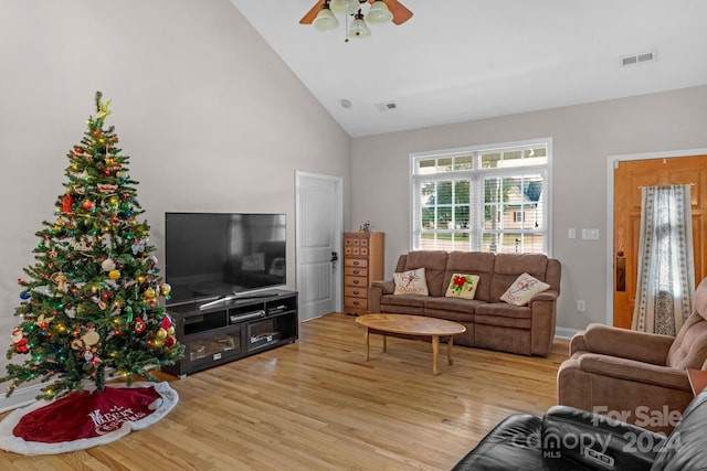 living room with ceiling fan, high vaulted ceiling, and light hardwood / wood-style flooring