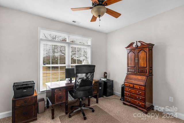 office space featuring light carpet and ceiling fan