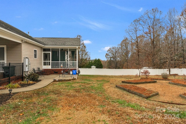 view of yard with a sunroom and a patio