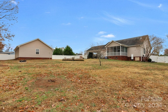 view of property exterior featuring a lawn and a sunroom