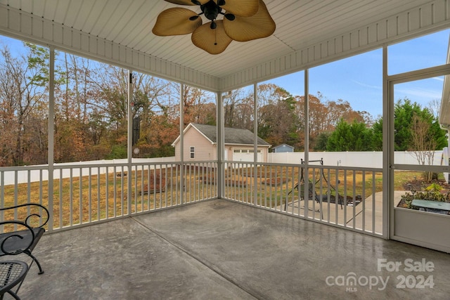 unfurnished sunroom featuring ceiling fan and a healthy amount of sunlight