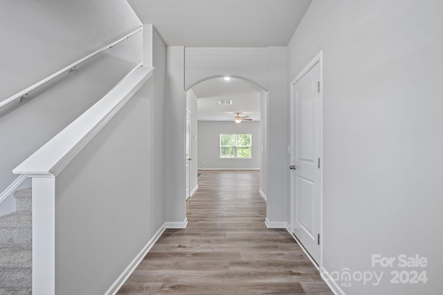 hallway with light hardwood / wood-style floors