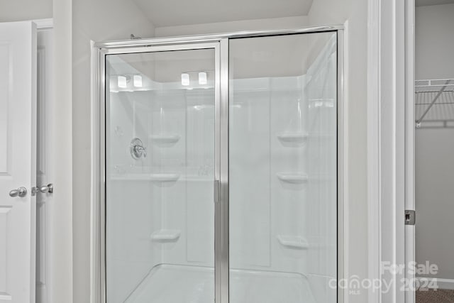 bathroom with a shower with shower door