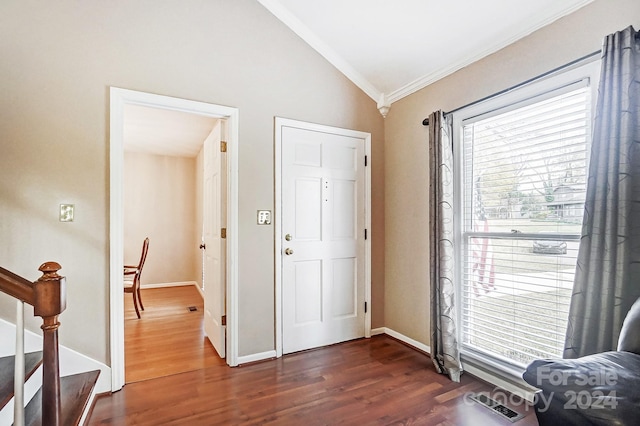 entryway with dark hardwood / wood-style floors, crown molding, and lofted ceiling