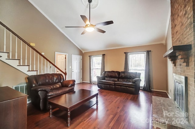 living room featuring ceiling fan, crown molding, high vaulted ceiling, a fireplace, and dark hardwood / wood-style floors