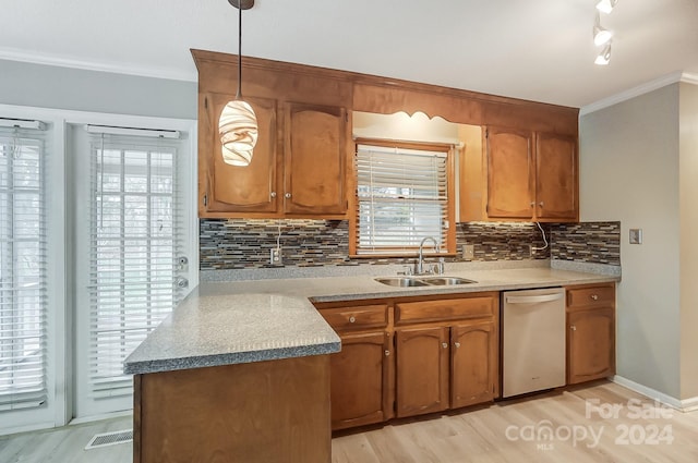 kitchen with dishwasher, sink, backsplash, pendant lighting, and light wood-type flooring