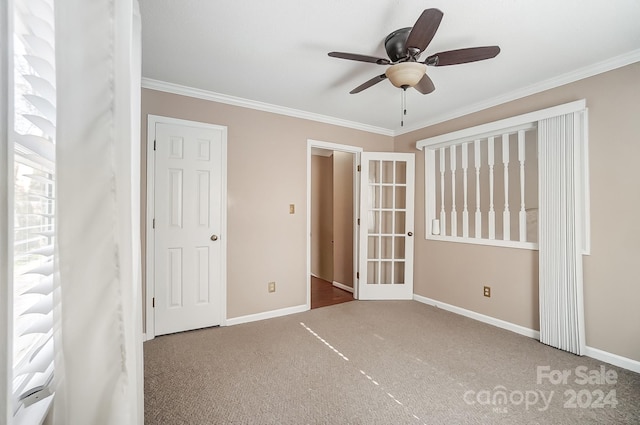 unfurnished bedroom with carpet flooring, ceiling fan, ornamental molding, and a closet