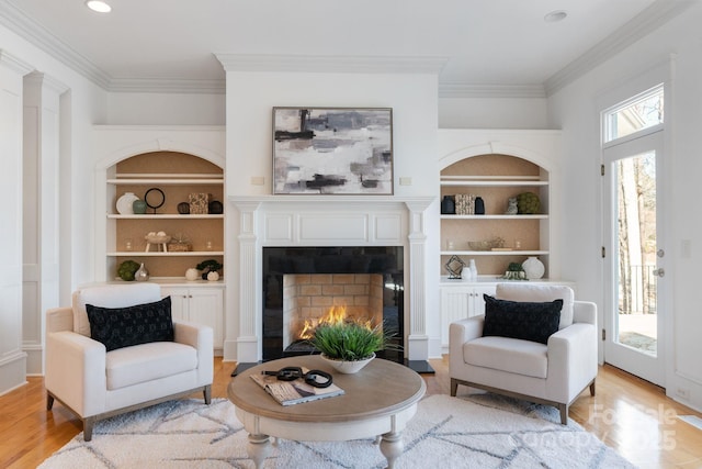 living area with built in shelves, plenty of natural light, and a fireplace