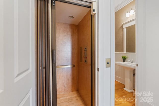 bathroom featuring wood-type flooring and elevator