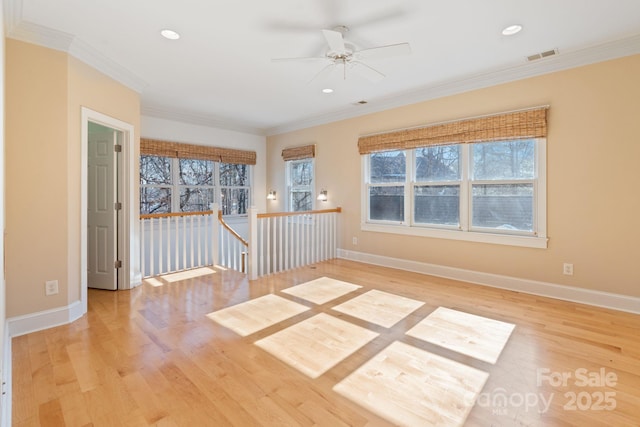 empty room with crown molding, light hardwood / wood-style floors, and ceiling fan