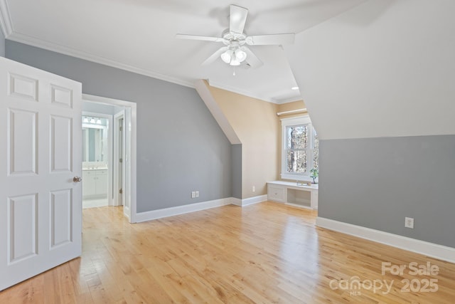 bonus room featuring ceiling fan, built in desk, and light hardwood / wood-style floors