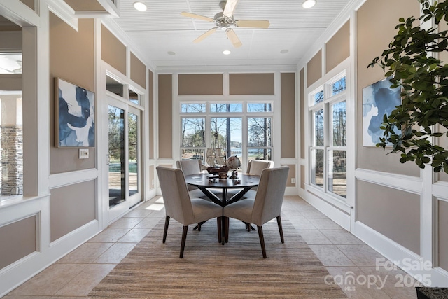 sunroom / solarium featuring ceiling fan