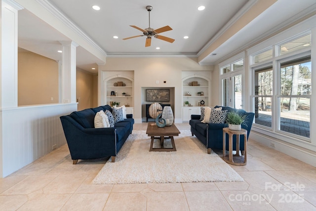 living room featuring light tile patterned floors, built in shelves, ornamental molding, and ornate columns