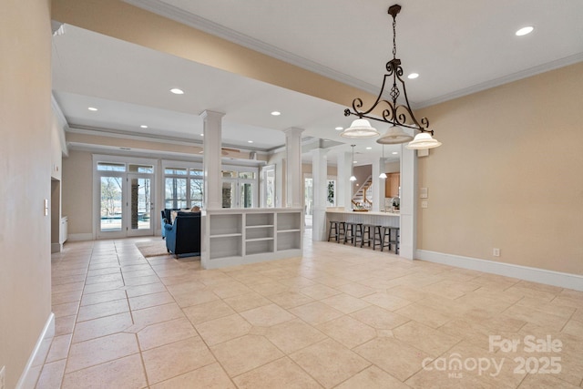 interior space featuring ornate columns, crown molding, and light tile patterned floors