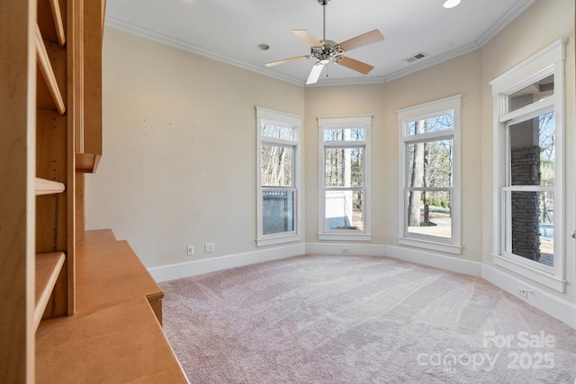 carpeted empty room with ornamental molding and ceiling fan