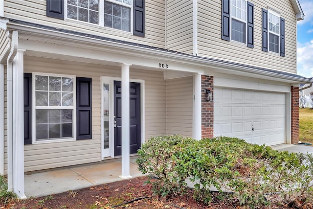 entrance to property with a porch and a garage