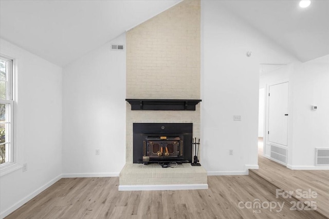 unfurnished living room with vaulted ceiling and light hardwood / wood-style floors