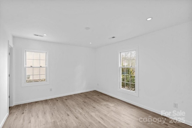 empty room featuring light hardwood / wood-style floors and a healthy amount of sunlight